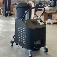 Rear-right view of the Depureco TB UP 3 with blower enclosure, suction hose, control switch, silencer, and wheeled chassis.