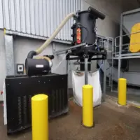 Depureco CVS central vacuum system discharging collected material into a bulk bag at an outdoor industrial facility.