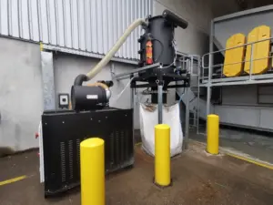 Depureco CVS central vacuum system discharging collected material into a bulk bag at an outdoor industrial facility.