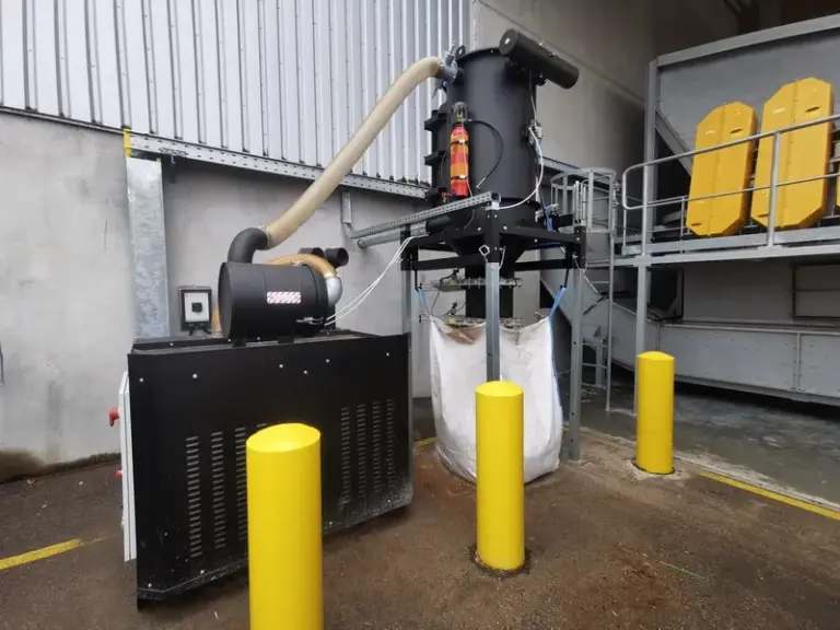 Depureco CVS central vacuum system discharging collected material into a bulk bag at an outdoor industrial facility.