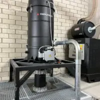 Depureco CVS centralized vacuum system installed above a floor-level material collection opening.