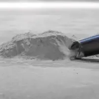 M100 JC industrial vacuum hose collecting fine powder and dust from a facility floor.