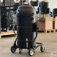 Rear view of the XM20 JC industrial vacuum showing its motor housing, filter chamber, frame, and mobile wheelbase.