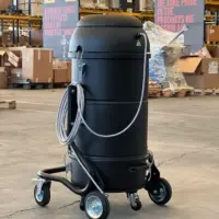 Rear-right view of the XM20 JC industrial vacuum with stored power cable, tubular frame, and collection-container latches.