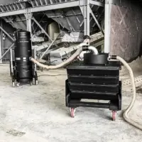Depureco PUMA industrial vacuum connected to a mobile tiltable pre-separator for bulk material recovery at an aggregate processing facility.