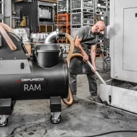 CNC sump vacuum recovering coolant and metal chips from a machine tank