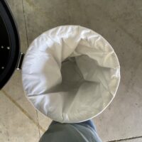 Top view inside a Depureco trims and scraps pre-separator showing the white internal filter bag.