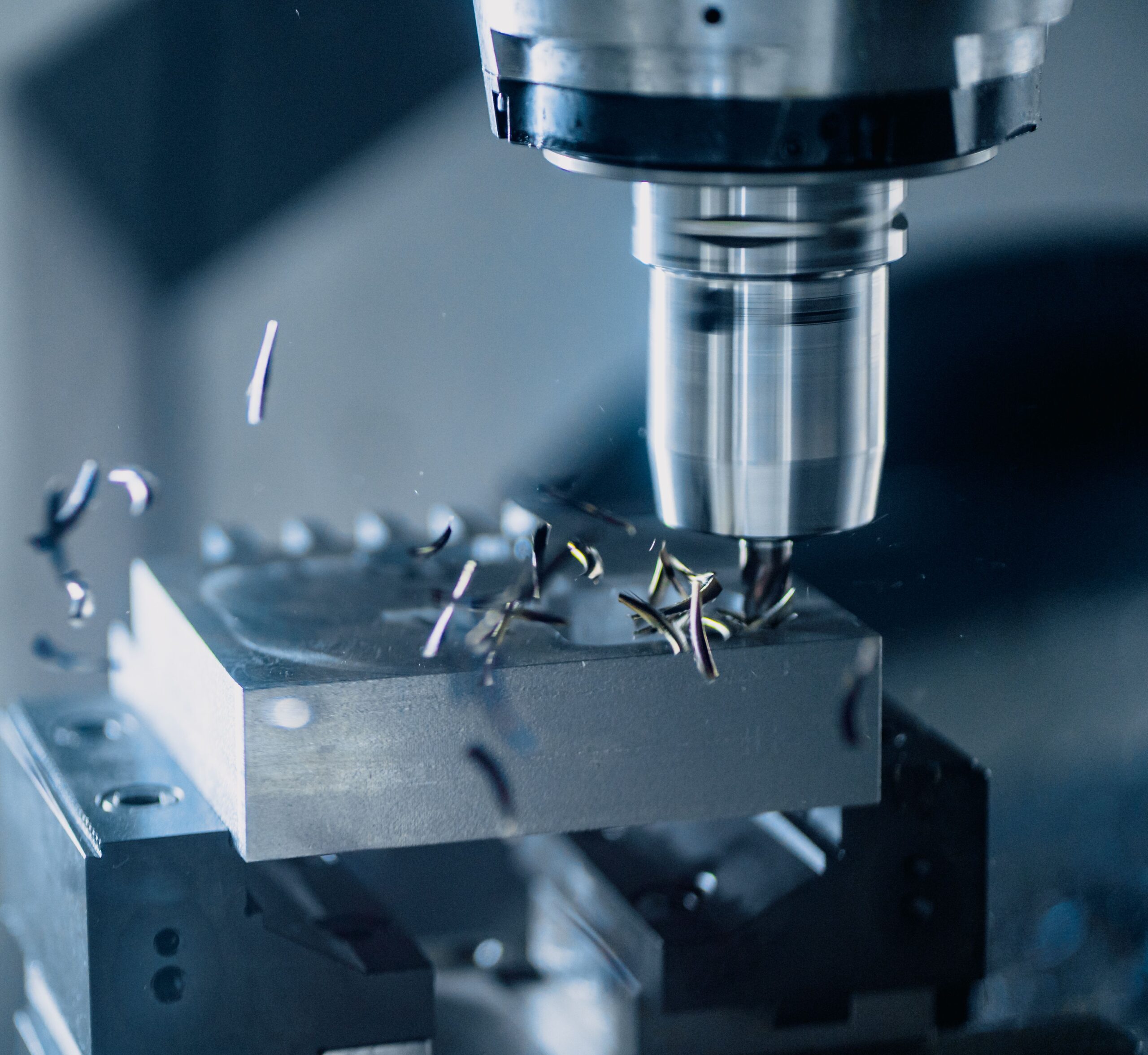 CNC spindle machining metal with chips and swarf during CNC milling.