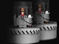 Single phase motors industrial vacuums Pair of single-phase vacuum motors for wet/dry industrial vacuums with metal cooling housings, on dark backdrop.