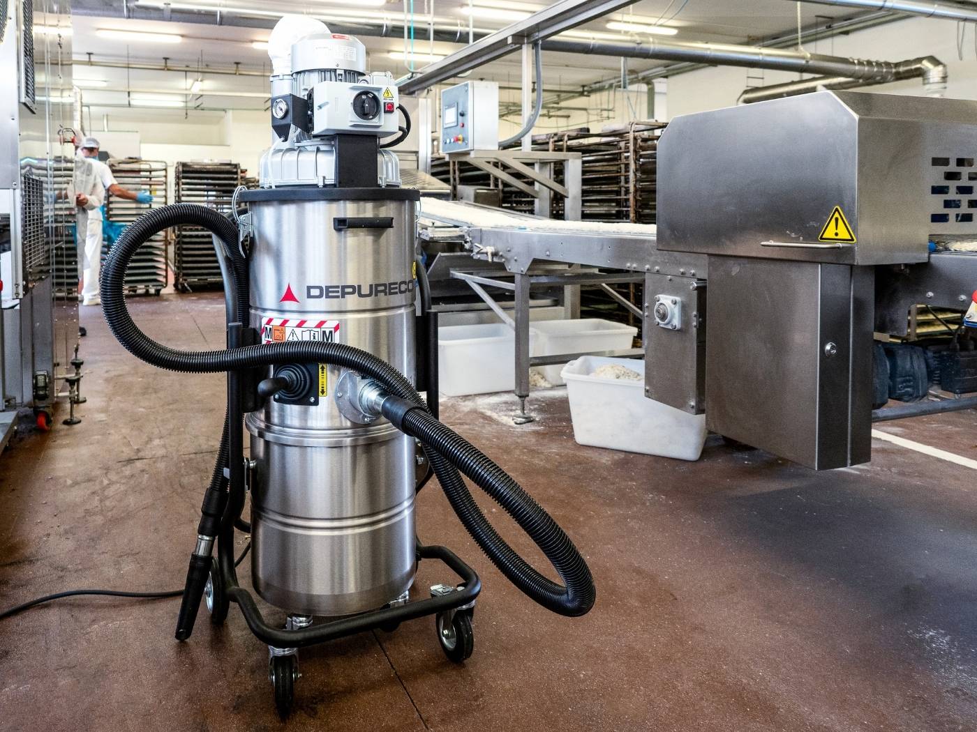 Depureco industrial vacuum operating in food processing facility next to production line